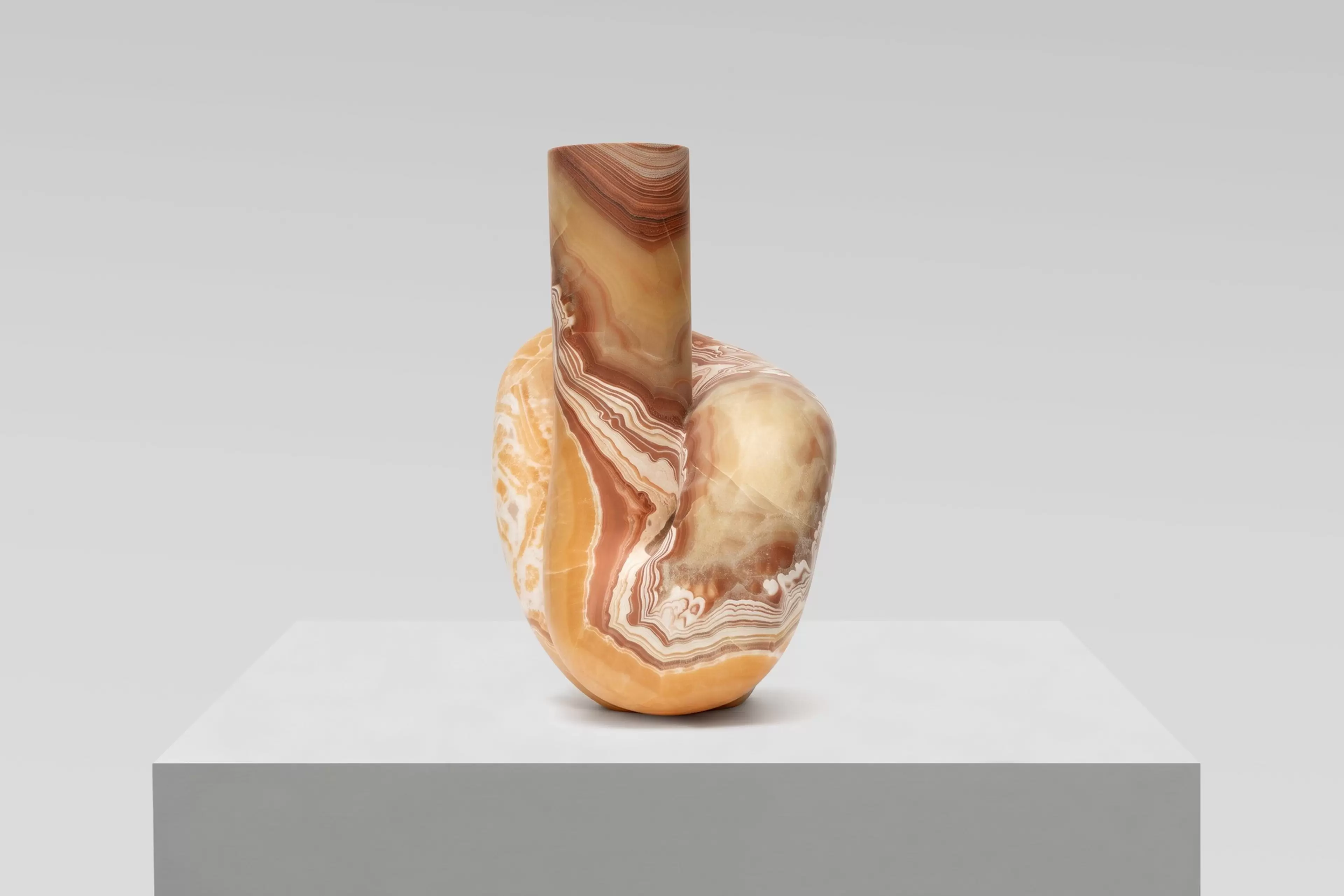 Pedro Reyes, Concordia (2026), red onyx sculpture. Artwork photographed against a white wall.