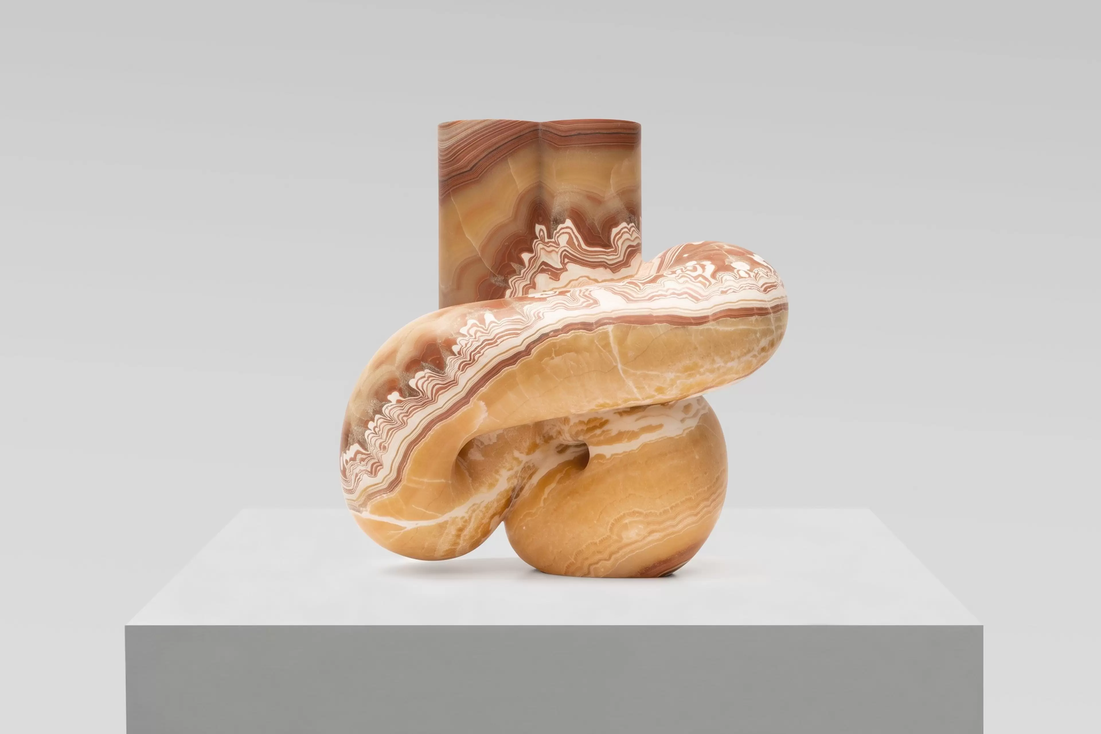 Pedro Reyes, Concordia (2026), red onyx sculpture. Artwork photographed against a white wall.