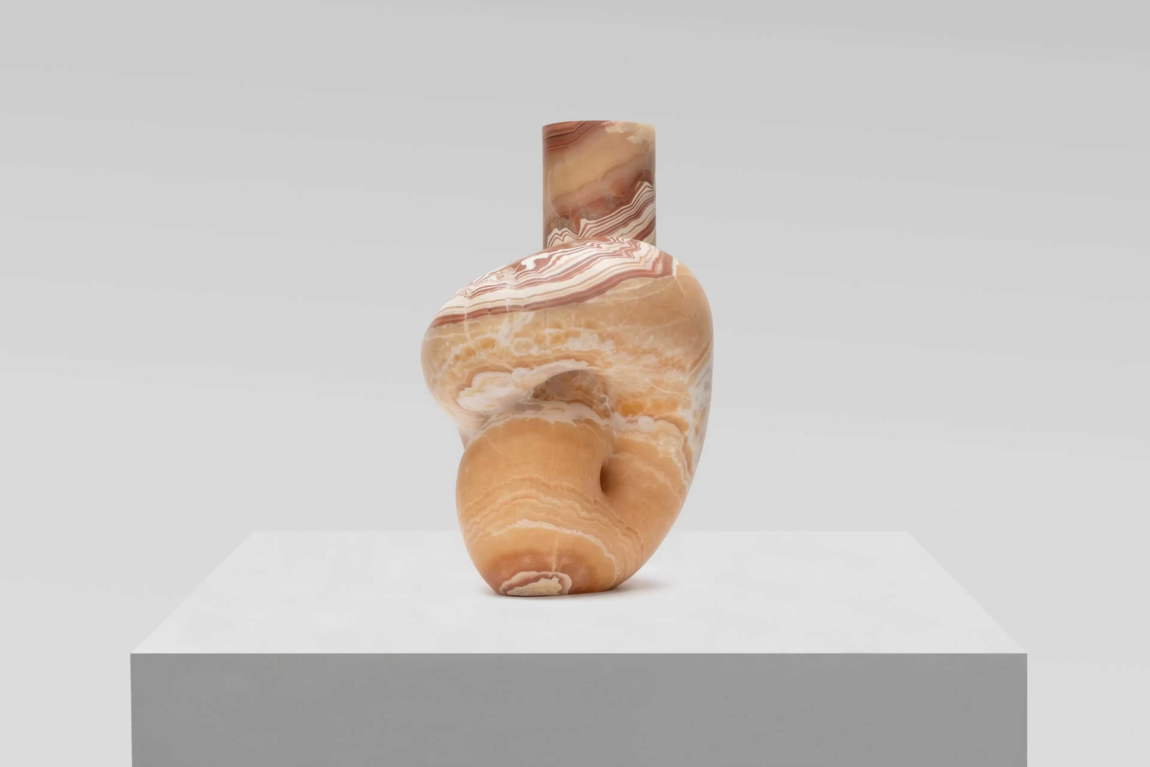 Pedro Reyes, Concordia (2026), red onyx sculpture. Artwork photographed against a white wall.